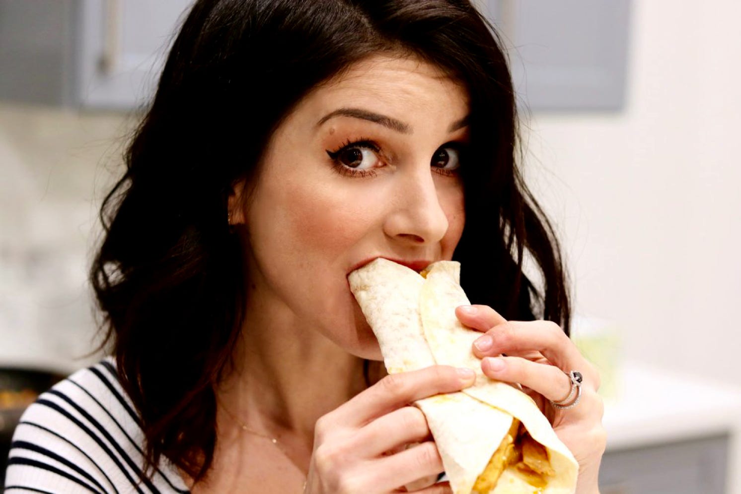 Lady eating a wrap at watford stalls